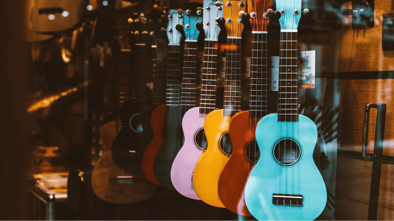 Bunte Ukulelen, die aufgereiht in einem Geschäft an der Wand hängen